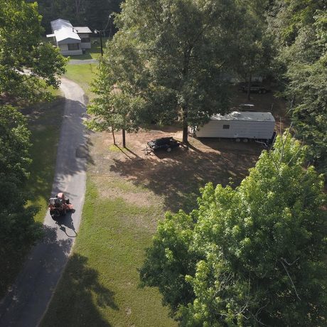 aerial view of park with grass and trees and parked rvs